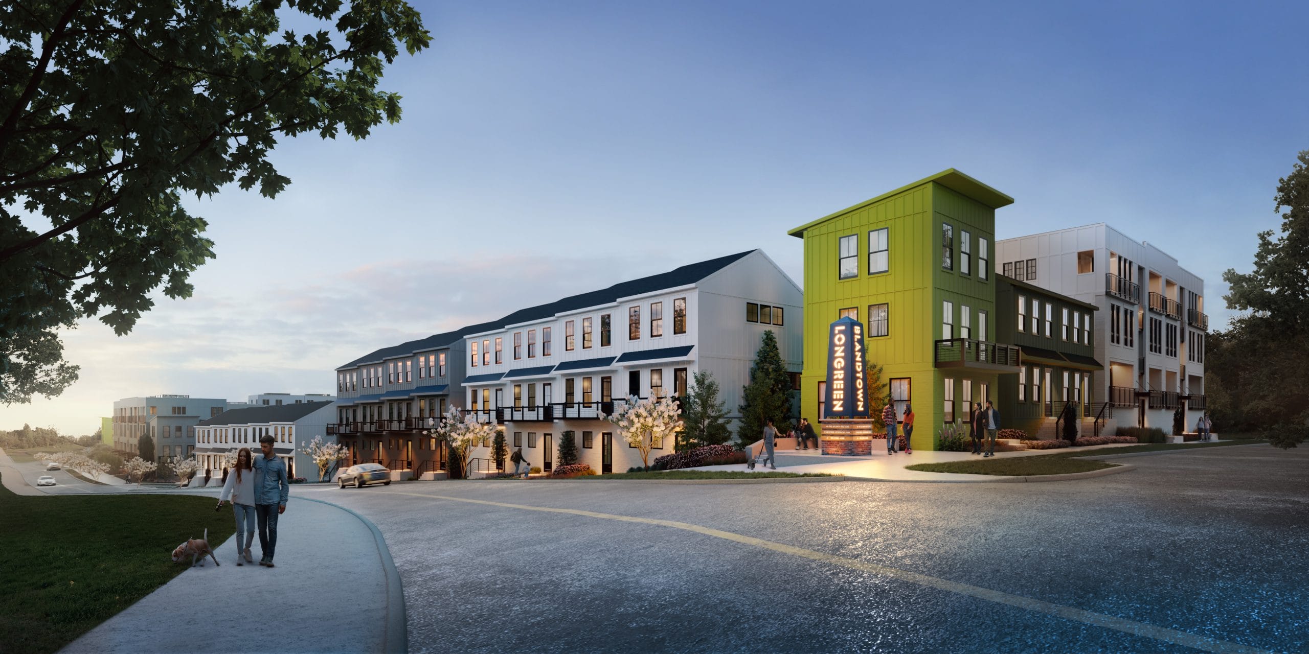 Residential area with townhomes & stacked condos, people walking, dog, trees lining the street, clear sky.