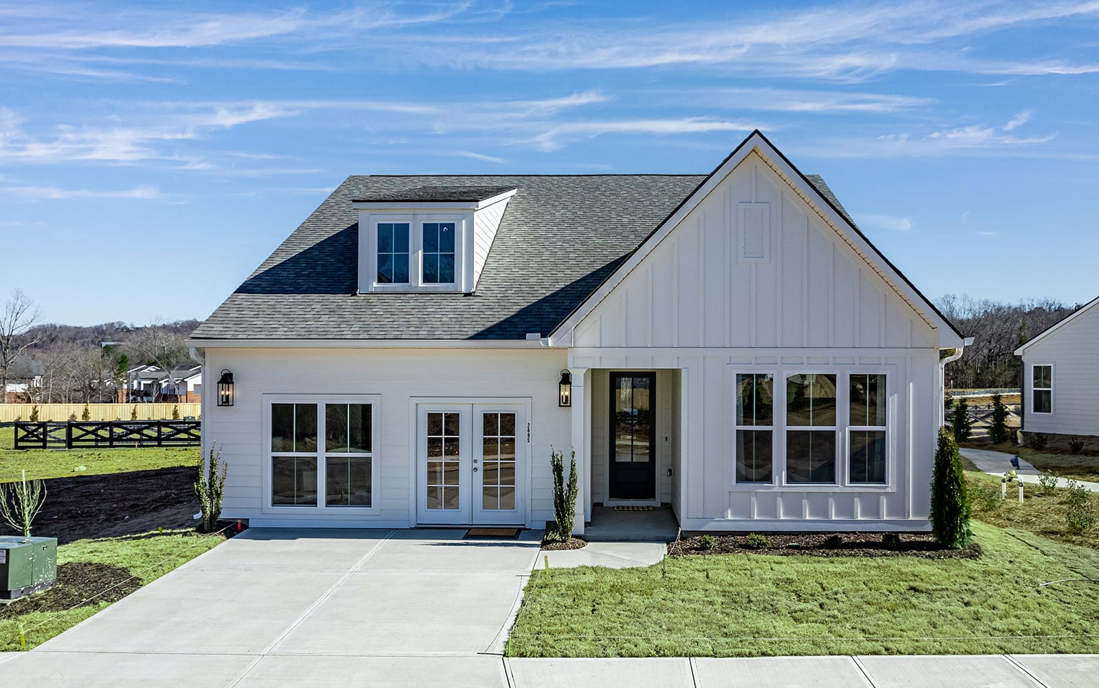 New single-story house with gable roof, white exterior, and attached garage.