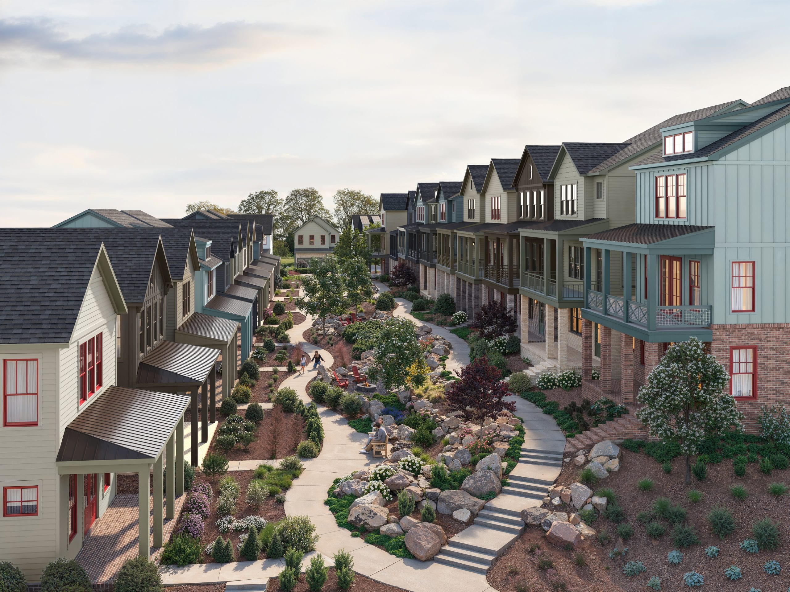 Residential area with two rows of houses facing each other, separated by landscaped pathway with rocks, plants, and shrubs.